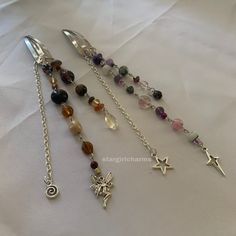 four different types of necklaces on a white sheet with the words charm charms written below them