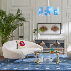 a living room filled with furniture and a blue rug