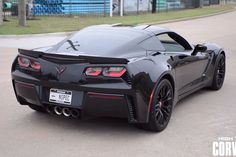 the rear end of a black sports car