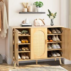 a wooden cabinet with shoes and purses on it next to a wall mounted shelf