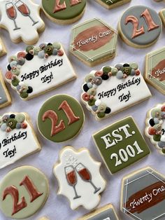 decorated cookies are arranged on a table for a 21st birthday cake and wine tasting party