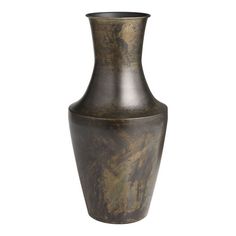 a large metal vase sitting on top of a white wall