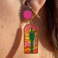 Peek through the TRANSLUCENT windows of these Earrings for a glimpse of desert magic! These "Stained Glass Saguaro" Earrings are made from etched brass & translucent enamel, which looks like stained glass! Let the sunshine in because when the light passes through these they come to life! Drawing inspiration from the intricate artistry of stained glass windows, I've illustrated these artworks to showcase stunning saguaro cacti & desert scenery as if they were a vibrant mosaic. Hand illustrated by Desert Magic, Landscape Earrings, Enchanting Landscape, Order Earrings, Desert Scenery, Stained Glass Earrings, Glass Jewelry Box, Logo Jewelry, Acrylic Pins