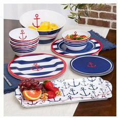 a table topped with plates and bowls filled with fruit