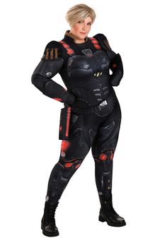 a woman in a black suit with red accents on her chest and arms, posing for the