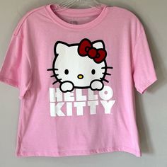 Adorable Medium Pink Color Cropped Hello Kitty Tee Shirt Is Lightweight Made From A Cotton Polyester Blend. New With Tags. Size Medium. Measurements Laying Flat Are Approximate (See Photos): Armpit To Armpit - 17” Length- 20” Cropped Length Trendy Pink Tops With Cat Design, Trendy Short Sleeve Tops With Hello Kitty Print, Hello Kitty Shirts, Fun Cotton Tops With Hello Kitty, Y2k Hello Kitty Print Crew Neck Top, Hello Kitty Print Y2k Crew Neck Top, Y2k Cotton Top With Cat Design, Hello Kitty Short Sleeve Top, Hello Kitty Crop Top