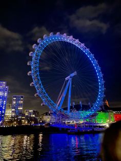 a ferris wheel lit up in the night sky