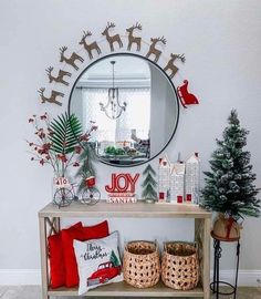 a christmas decorated entryway with a mirror and decorations