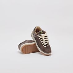 a pair of brown sneakers with white laces