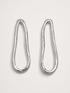 Long post earrings are sinuously shaped in highly polished silver-plated brass.  Silver-plated brass.  Stainless steel post backs.  Made in India.  Length: 2. 3" Plating, Banana Republic, Steel Post, Long Earrings, Post Earrings, Silver Plate, Silver Plated, Women Jewelry, Brass