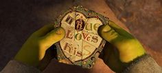 hands holding up a heart shaped box with words on it