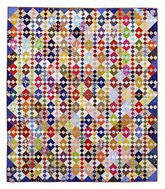 a multicolored quilt with squares and dots on it's sides, all in different colors