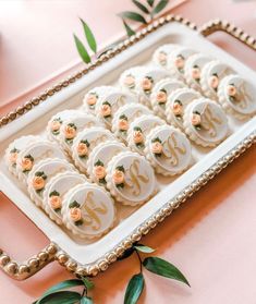 there is a tray with cookies on it and some flowers in the middle that have been decorated