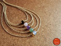 This delicate and bohemian choker features a gemstone adorned with brass beads and set with cream waxed threads. Perfect for layered boho style. The necklace is adjustable in length with a sliding knot, so that you can wear it short or long and the cord ends in two delicate endings with smaller gemstone and brass beads. Each gemstone is around 9mm. *If you want another color of thread for your necklace, see last picture* From down to up the gemstones are: 1) Opalite 2) Aventurine 3) Amethyst 4) Macrame Choker, Mala Jewelry, Handmade Crystal Jewelry, Gemstone Choker, Diy Friendship Bracelets Patterns, Layered Chokers, Necklace Layered, Medieval Jewelry, Funky Jewelry