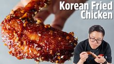 a person holding up a piece of food in front of their face with the words korean fried chicken on it