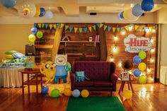 a room decorated with balloons and decorations