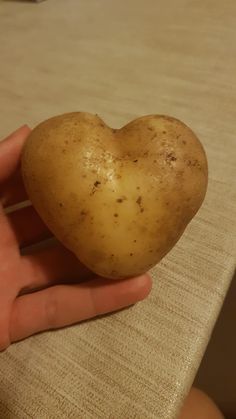 a heart shaped potato in someone's hand