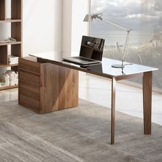 a desk with a laptop on it in front of a large window overlooking the ocean