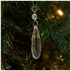 a glass ornament hanging from a christmas tree