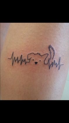 a dog is heartbeat tattoo on the thigh