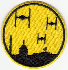 a yellow and black patch with the word star wars on it