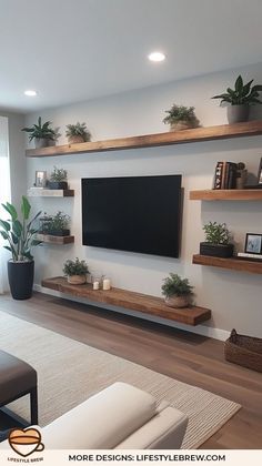 a flat screen tv mounted to the side of a wall in a living room with potted plants