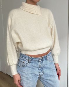 "Gorgeous 1960s Vintage Knit Cream Lambswool and Angora Blend High Neck Sweater | Made in Australia | Super Soft | Classic Minimal Style Marked Size: Not marked. but fits like a modern day small Material: 60% Lambswool, 30% Angora, 10% nylon Made in Australia Model is a size small and is pictured wearing a small. Fit perfectly relaxed (as pictured). Measurements (laying flat): arm length: 22\" / shoulder to shoulder: 17\" / underarm to underarm: 29\" / length: 21\" Condition: in gorgeous vintage condition All sales are final." Vintage Sweater For Layering, Vintage Knitted Sweater For Layering, Cozy Wool Top In Cream, Cozy Wool Cream Top, Cozy Cream Wool Top, Vintage Knit Sweater With Ribbed Collar, Vintage Wool Turtleneck Sweater, Retro Knit Turtleneck Sweater, Retro Turtleneck Knit Sweater