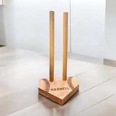 two wooden baseball bats on top of a base