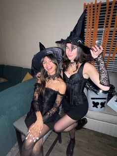 two women dressed up as witches posing for the camera