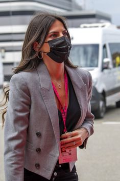 a woman wearing a face mask and jacket