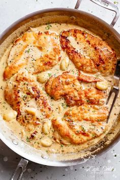 a skillet filled with chicken covered in gravy