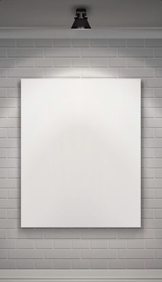 an empty white board hanging on the wall in a room with brick walls and flooring