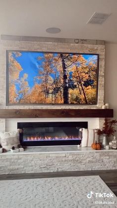 a large television mounted above a fireplace in a living room