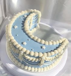 a blue and white cake sitting on top of a table