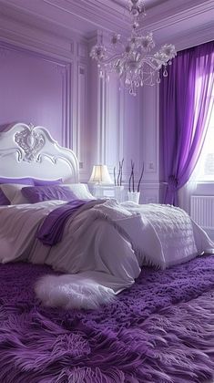 a bedroom with purple and white decor on the walls, carpeted flooring and a chandelier hanging from the ceiling