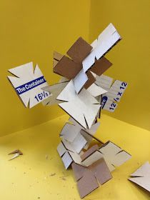 a pile of cut up pieces of paper sitting on top of a yellow tablecloth covered floor