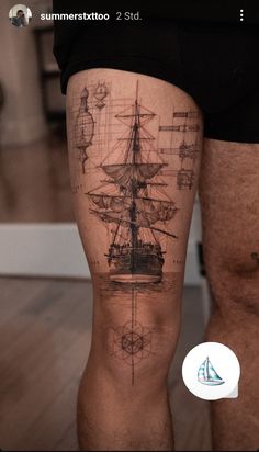 a man's leg with a ship tattoo on it