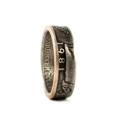 1981 Washington Quarter Coin Ring. All of our quarter rings are handmade using actual United States coins! The shank (width of the ring) of these rings measures approx. 6 to 7mm, the larger the ring the narrower the band becomes. These liberty quarter coin rings make great birthday and anniversary gifts. Stand out with this conversation starter! To make our coin rings we punch the center out of the coin, we have created different add ons that use the punch outs. On the regular band band coin rin Quarter Ring, Coin Rings, Quarter Dollar, Punch Out, Coin Ring, Have Metal, Us Coins, Add Ons, Antique Finish