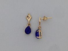 "SOLID 14KT YELLOW GOLD DANGLE EARRINGS NATURAL SAPPHIRE IS 5x7 mm PEAR SHAPE EACH  SAPPHIRE IS CABOCHON CUT NATURAL DIAMOND IS 0.02 TCW EARRING LENGTH IS 5/8\" INCH COMES IN GIFT BOX"