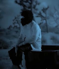 a man sitting on top of a piano in the dark