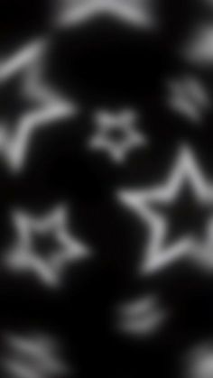 an abstract black and white background with stars in the middle, some blurry to the foreground