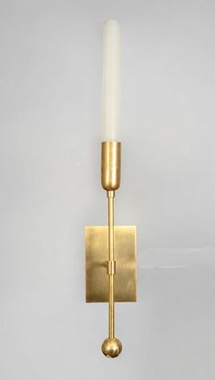 Brighten your home with the TASSEL 1 Sconce, a stunning wall light that beautifully merges modern design with mid-century charm. Featuring a sleek glass tube, this sconce provides soft, ambient illumination, creating a warm and inviting atmosphere in any room. The raw brass accents add a touch of elegance, enhancing the overall aesthetic and making it a versatile choice for various decor styles. Ideal for hallways, living rooms, or bedrooms, the TASSEL 1 Sconce serves both functional and decorative purposes, effortlessly elevating your interior space. Its minimalist design ensures it complements rather than overwhelms your decor, while the durable materials promise longevity and quality. Easy to install, this wall sconce is perfect for anyone looking to enhance their lighting solutions wit Bathroom Vanity Sconces, Bronze Sconces, Brass Sconces, Brass Accents, Elegant Lighting, Light Sconces, Modern Glass, Live Light, Ceiling Light Fixtures