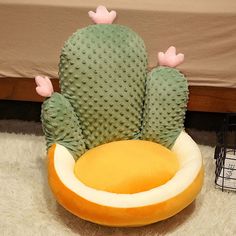 a large cactus sitting on top of a pillow in the middle of a room next to a bed