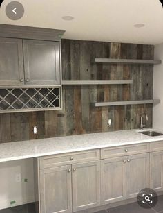 an empty kitchen with wooden cabinets and marble counter tops in the middle of the room