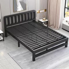 there is a black bed frame in the middle of a room with white walls and flooring