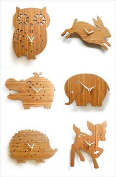 four different wooden clocks with animals on them