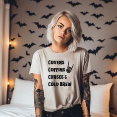 Covens Coffins Coffee Cold Brew Shirt Skeleton Hands, Vintage Halloween, Retro Fall Shirt, Witch Shirt, Retro Halloween Shirt, Creepy Gift ️ Embrace the witchy vibes with our "Covens Coffins Coffee Cold Brew" shirt! Perfect for those who love all things mystical and caffeinated, this shirt features a stylish and whimsical design that combines covens, coffins, and cold brew coffee. Available in various sizes and colors, it's made from soft, comfortable fabric that's perfect for everyday wear. 🌙? Halloween Diy Shirts For Women, Circuit T Shirt Designs, Halloween Work Outfit Ideas, Fall Shirts Vinyl, Diy Halloween Shirts, Creepy Gift, Halloween Moms, Funny T Shirt Sayings, Halloween Retro