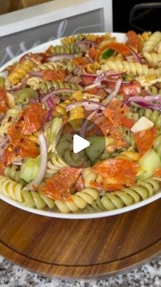 a bowl filled with pasta and vegetables on top of a table