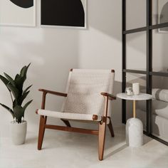 a white chair sitting next to a table with a potted plant on top of it