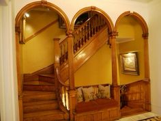 the stairs are made of wood and have arched balconies